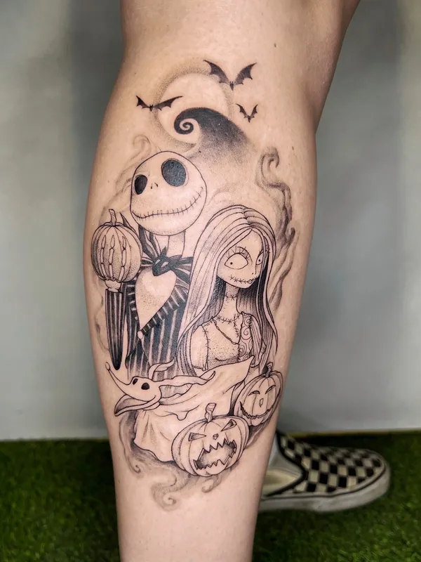 Black-and-grey Nightmare Before Christmas tattoo of Jack and Sally with Zero, pumpkins and bats on a calf