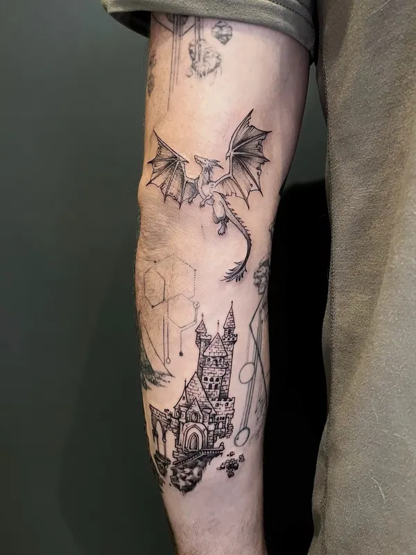 Fine-line black-and-grey tattoo of a dragon flying above a castle with geometric hexagons on a forearm