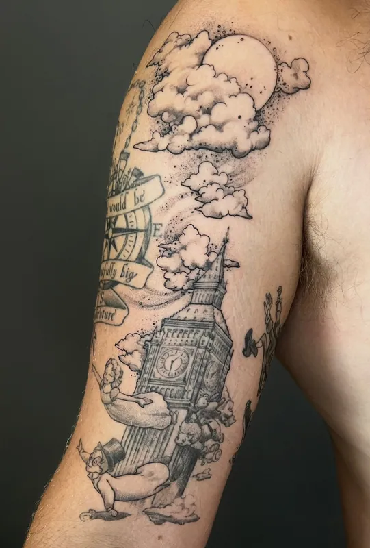 Black-and-grey Peter Pan tattoo of Big Ben with figures flying past clouds and a full moon on an upper arm