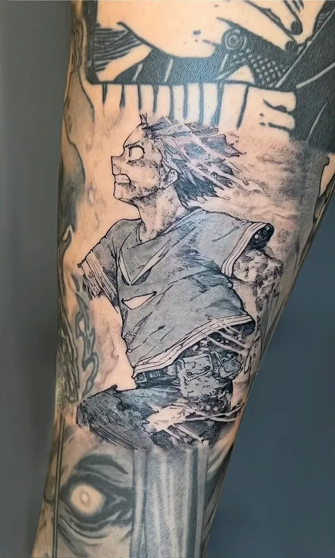 Black-and-grey manga-style sleeve tattoo of a spiky-haired anime hero in a torn shirt, framed by panel borders, on a forearm