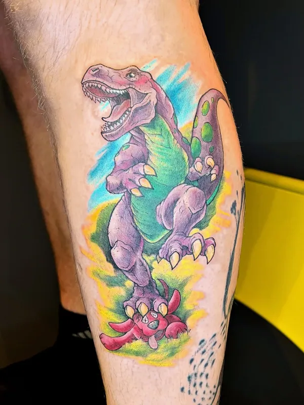 Color cartoon T-rex tattoo in purple and green stepping on a small red creature on a calf